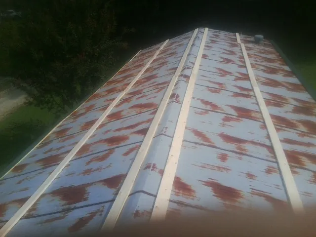 Rusted metal roof panels with new wood purlins before replacement — Storm Damage Roof Repair in Edison by Roofing Brothers