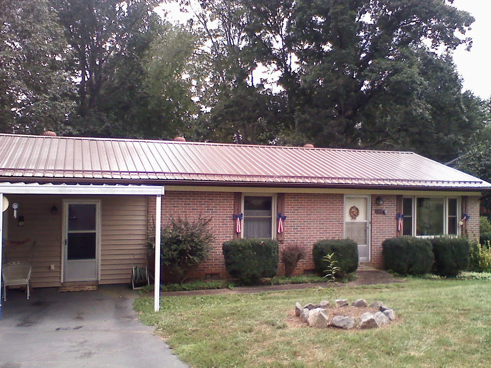 Bronze metal roof and carport on a brick ranch home — Roof Repair work by our crew in Edison