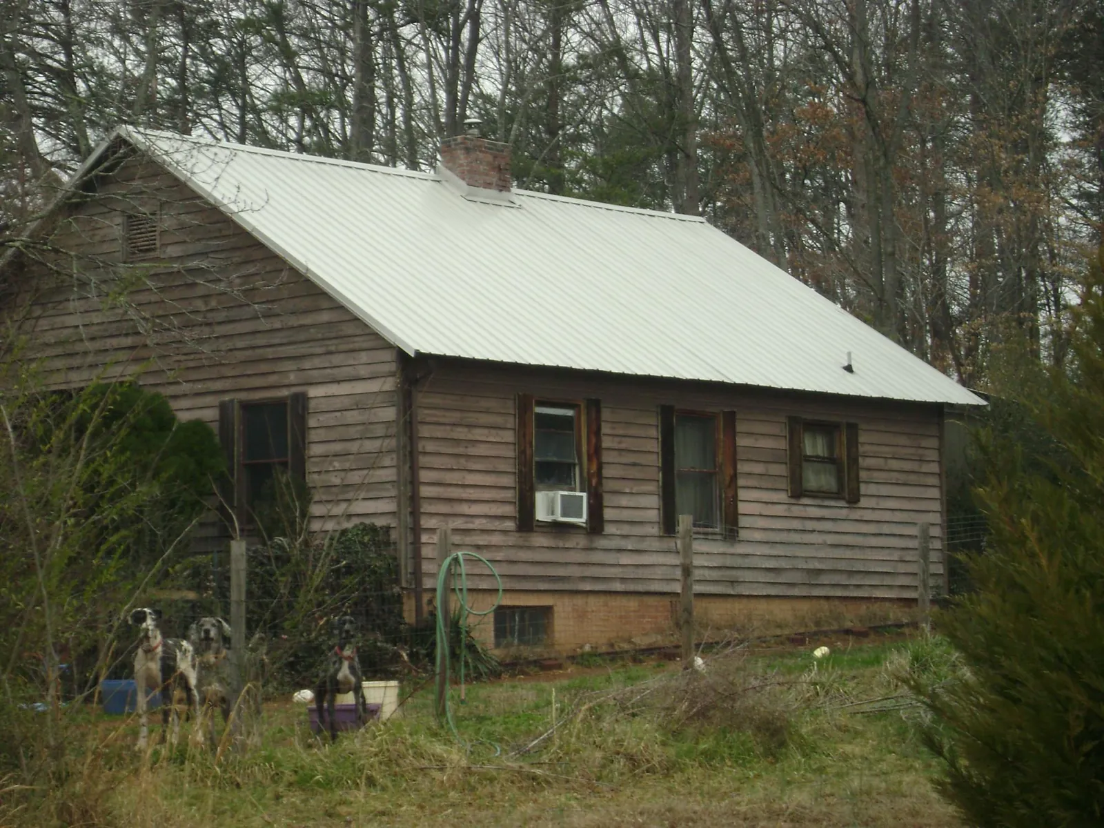 White metal roof on an old wood sided farmhouse, from a Metal Roof Installation job in Edison